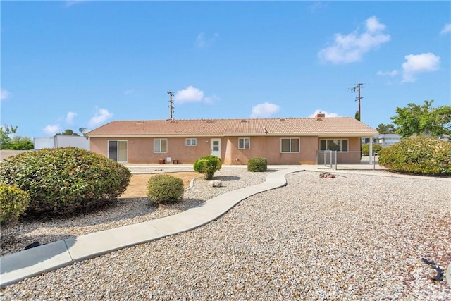 19115 Seneca, Apple Valley, CA 92307 - rear view of house with a tiled roof, stucco siding, a patio, and a chimney