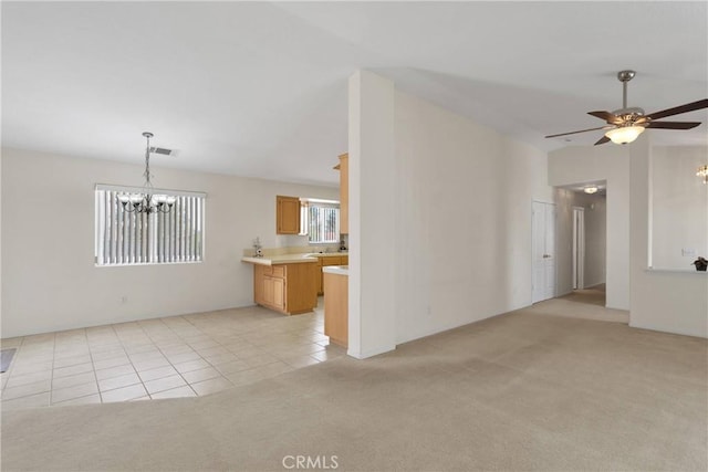 19115 Seneca, Apple Valley, CA 92307 - unfurnished living room featuring a chandelier, light carpet, light tile patterned floors, and ceiling fan
