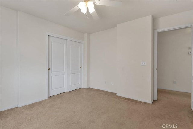 19115 Seneca, Apple Valley, CA 92307 - unfurnished bedroom with light colored carpet, a closet, and a ceiling fan