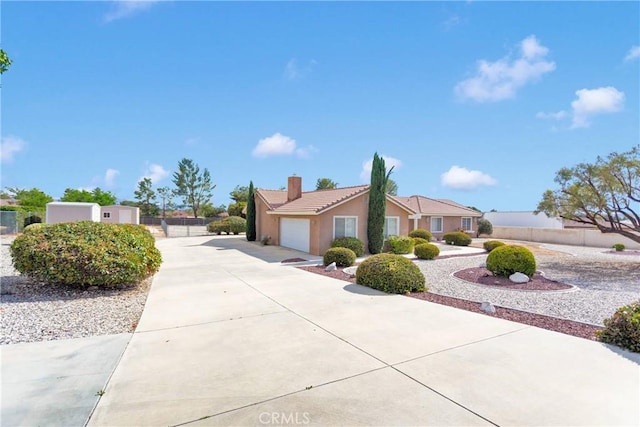 19115 Seneca, Apple Valley, CA 92307 - view of property exterior with a tile roof, concrete driveway, an attached garage, a chimney, and fence