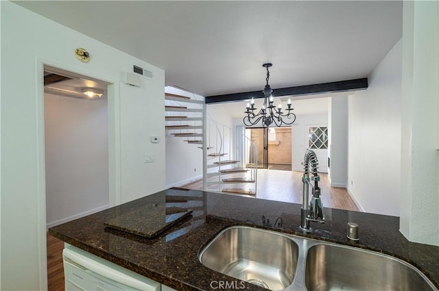 2900 Madison Ave Unit D16, Fullerton, CA 92831 - kitchen featuring a sink, dishwasher, wood finished floors, dark stone countertops, and a chandelier