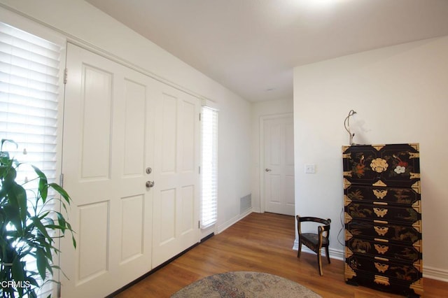 foyer entrance featuring wood finished floors and baseboards