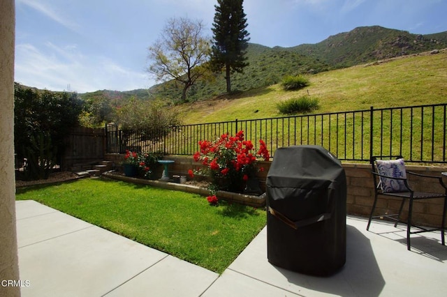 view of yard with a mountain view and a patio