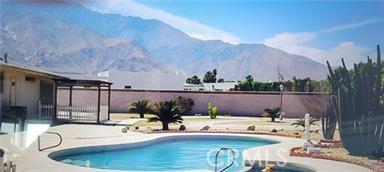 1880 Sharon Rd, Palm Springs, CA 92262 - view of pool featuring a patio area, a mountain view, and fence