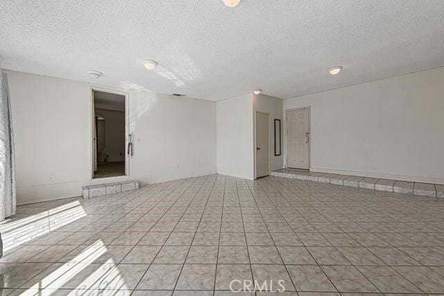 1880 Sharon Rd, Palm Springs, CA 92262 - unfurnished room with a textured ceiling and light tile patterned flooring