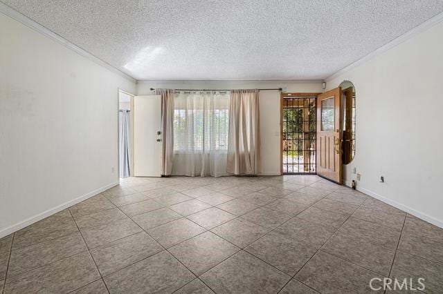 1880 Sharon Rd, Palm Springs, CA 92262 - unfurnished room with a textured ceiling, crown molding, tile patterned floors, and baseboards