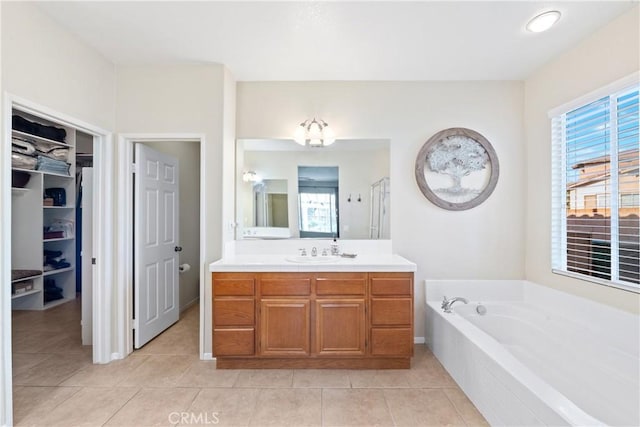 35475 Calendula Cir, Winchester, CA 92596 - bathroom with tile patterned flooring, vanity, a bath, and a walk in closet