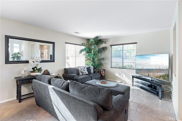 35475 Calendula Cir, Winchester, CA 92596 - living room featuring healthy amount of natural light, light tile patterned floors, and baseboards
