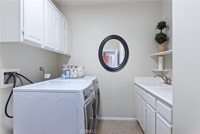 35475 Calendula Cir, Winchester, CA 92596 - clothes washing area with washing machine and clothes dryer, cabinet space, light tile patterned floors, and baseboards