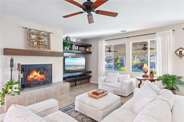 35475 Calendula Cir, Winchester, CA 92596 - living room featuring ceiling fan, a warm lit fireplace, tile patterned flooring, and baseboards