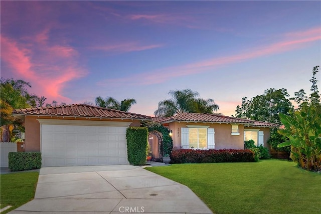 35475 Calendula Cir, Winchester, CA 92596 - view of front of home featuring driveway, stucco siding, a tile roof, a lawn, and an attached garage