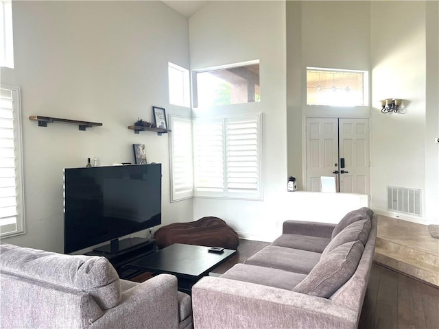 13564 Esprit Ave, San Diego, CA 92128 - living area featuring a towering ceiling, hardwood / wood-style floors, healthy amount of natural light, and baseboards