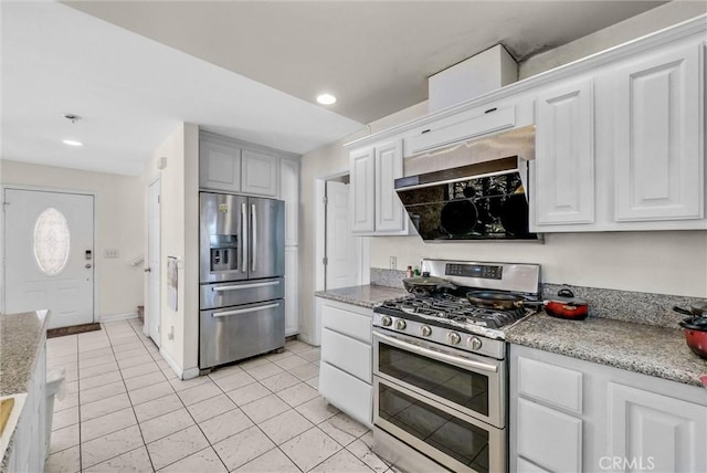 1451 W 10th St, Pomona, CA 91766 - kitchen featuring appliances with stainless steel finishes, light tile patterned floors, white cabinetry, recessed lighting, and range hood