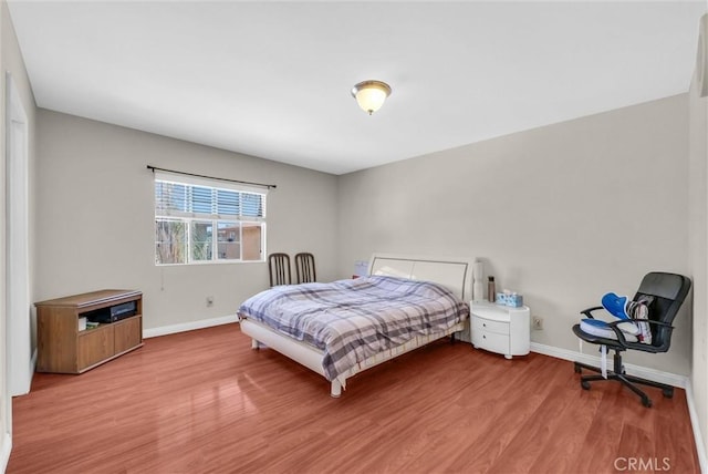 1451 W 10th St, Pomona, CA 91766 - bedroom featuring wood finished floors and baseboards