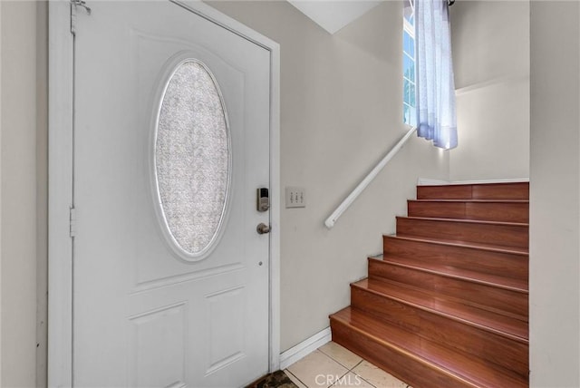 1451 W 10th St, Pomona, CA 91766 - entryway with stairway, light tile patterned flooring, and baseboards