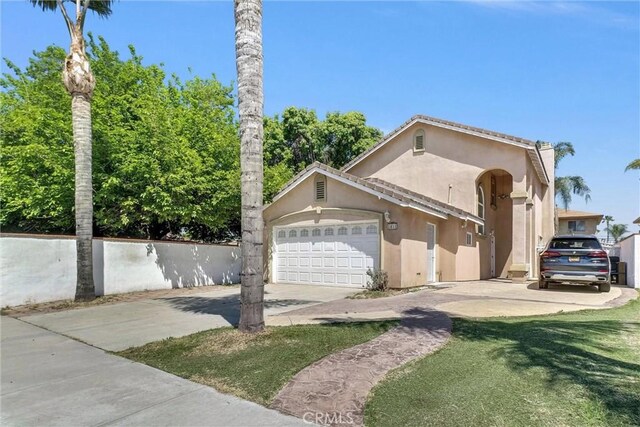 1451 W 10th St, Pomona, CA 91766 - view of home's exterior with stucco siding, concrete driveway, and an attached garage