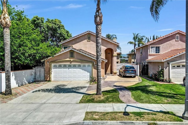 1451 W 10th St, Pomona, CA 91766 - mediterranean / spanish-style house featuring fence, concrete driveway, stucco siding, and a garage