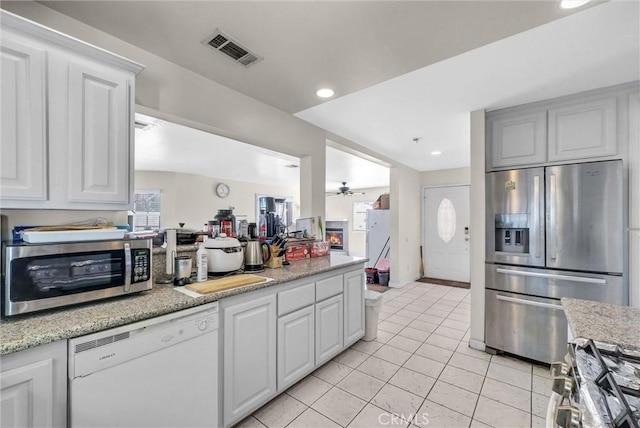 1451 W 10th St, Pomona, CA 91766 - kitchen with appliances with stainless steel finishes, ceiling fan, light tile patterned flooring, recessed lighting, and white cabinets