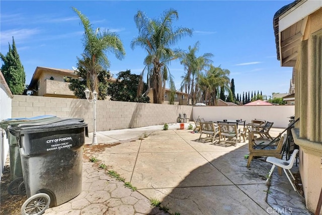 1451 W 10th St, Pomona, CA 91766 - view of patio with outdoor dining area and a fenced backyard