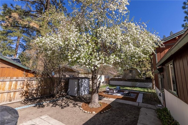615 Elysian Blvd, Big Bear City, CA 92314 - fenced backyard with a patio area, a storage shed, and an outdoor structure