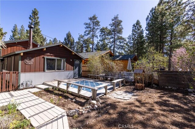 615 Elysian Blvd, Big Bear City, CA 92314 - rear view of house with fence and a pool