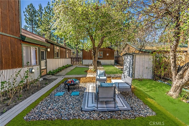 615 Elysian Blvd, Big Bear City, CA 92314 - view of yard with a storage shed, an outbuilding, a patio area, and an outdoor fire pit