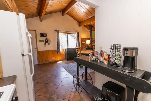 615 Elysian Blvd, Big Bear City, CA 92314 - kitchen featuring freestanding refrigerator, a wood stove, wooden ceiling, wainscoting, and wooden walls