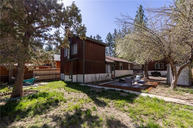 615 Elysian Blvd, Big Bear City, CA 92314 - view of home's exterior featuring fence, a patio, and an outdoor hangout area