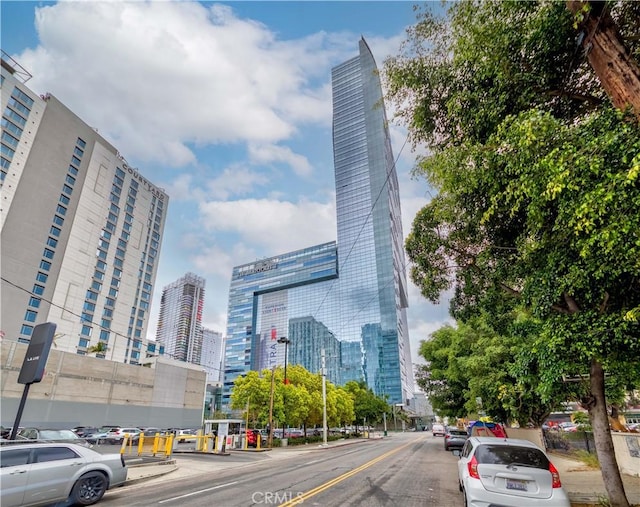 view of asphalt road with a view of city