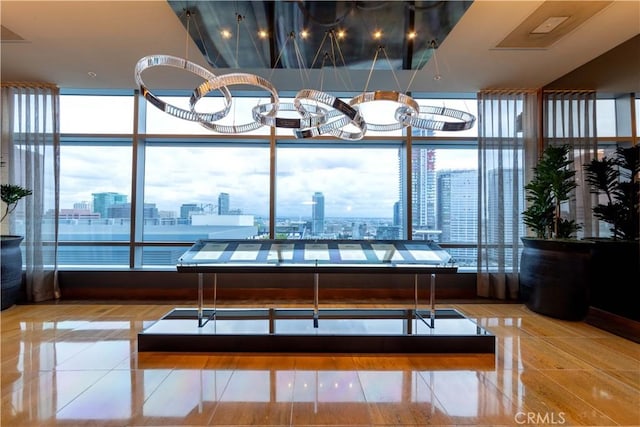 tiled dining room with a view of city, floor to ceiling windows, and plenty of natural light
