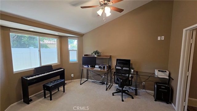 office with vaulted ceiling, plenty of natural light, carpet flooring, ceiling fan, and baseboards