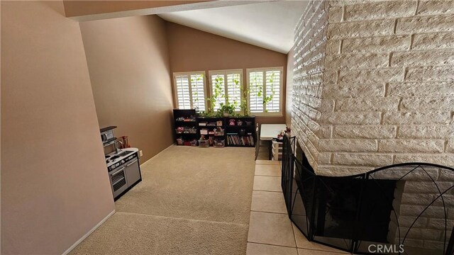 interior space with carpet and vaulted ceiling