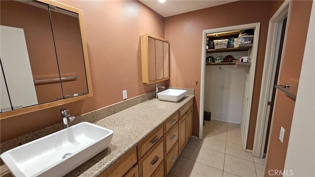 bathroom with tile patterned flooring and double vanity
