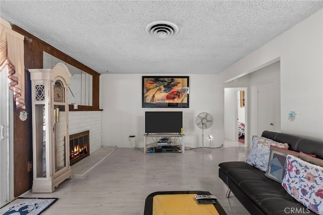 11242 Kamloops St, Sylmar, CA 91342 - living area with a textured ceiling, a fireplace, and wood finished floors