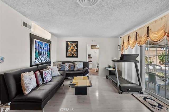 11242 Kamloops St, Sylmar, CA 91342 - living room featuring a textured ceiling and wood finished floors