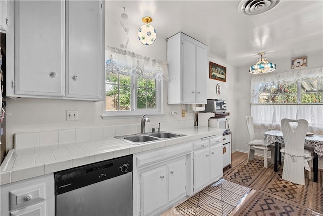 11242 Kamloops St, Sylmar, CA 91342 - kitchen with stainless steel dishwasher, a sink, tile counters, white cabinetry, and white microwave