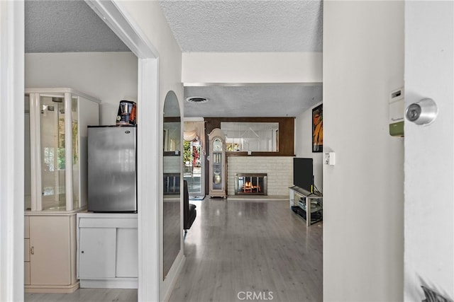 11242 Kamloops St, Sylmar, CA 91342 - hallway with a textured ceiling, wood finished floors, and arched walkways
