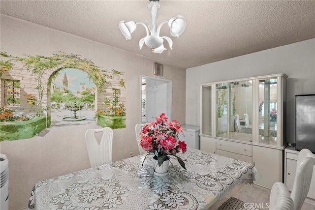 11242 Kamloops St, Sylmar, CA 91342 - dining area featuring a chandelier, a textured ceiling, light wood-style flooring, and plenty of natural light