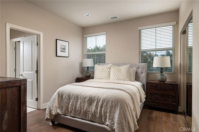 bedroom with wood finished floors and recessed lighting