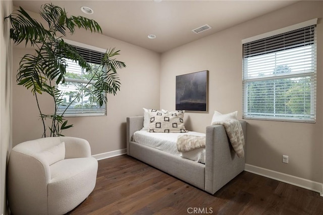 sitting room with baseboards and dark wood-style floors