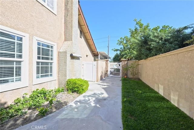 20720 Cottonwood Rd, Yorba Linda, CA 92887 - view of side of home featuring a gate and stucco siding