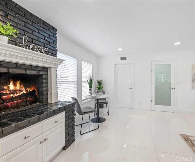 20720 Cottonwood Rd, Yorba Linda, CA 92887 - kitchen with a fireplace, white cabinets, recessed lighting, dark stone counters, and light tile patterned floors