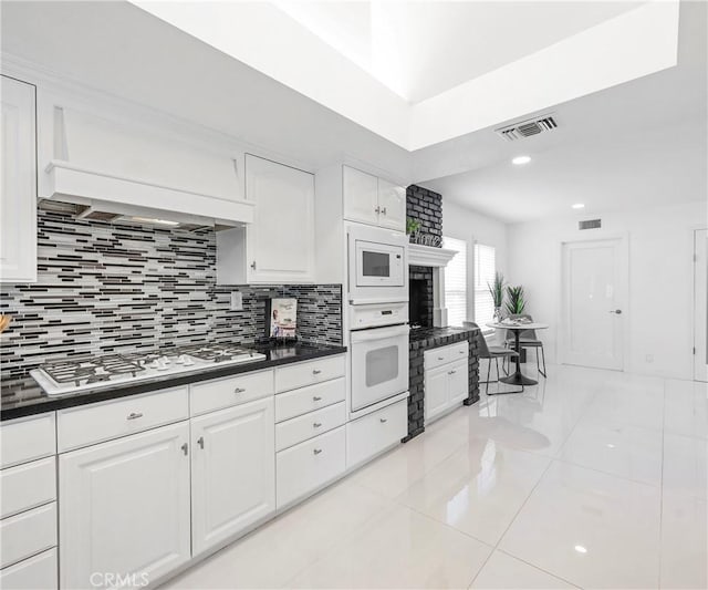 20720 Cottonwood Rd, Yorba Linda, CA 92887 - kitchen with white appliances, light tile patterned flooring, dark countertops, white cabinets, and recessed lighting