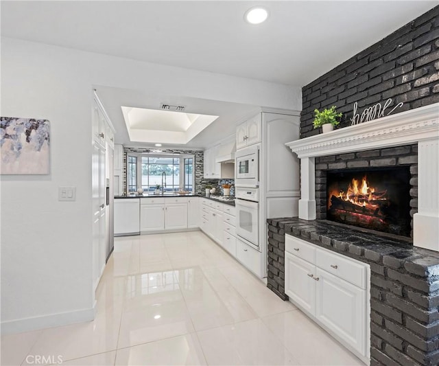 20720 Cottonwood Rd, Yorba Linda, CA 92887 - kitchen featuring white appliances, dark countertops, light tile patterned flooring, white cabinets, and recessed lighting