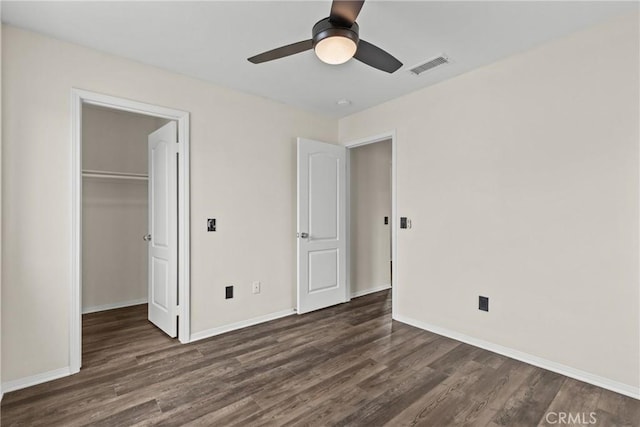 2535 Canterbury Ln, Simi Valley, CA 93063 - unfurnished bedroom with dark wood-style flooring, a spacious closet, baseboards, a closet, and a ceiling fan