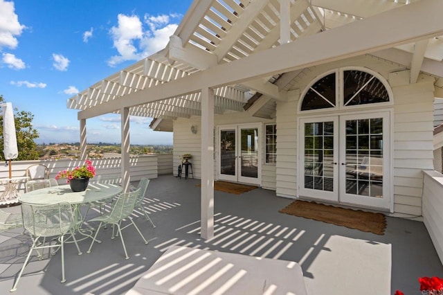 view of patio / terrace featuring french doors, a pergola, and outdoor dining area