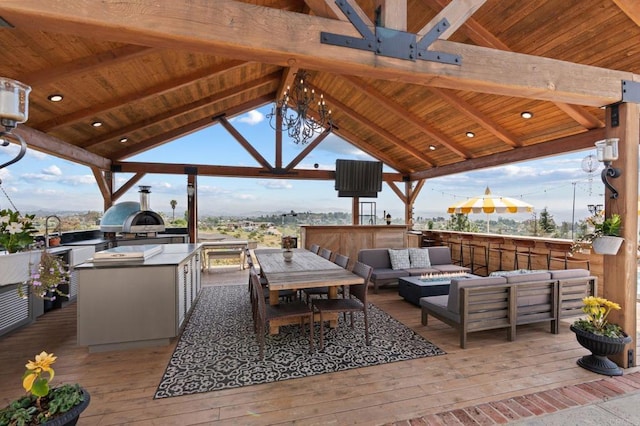 view of patio / terrace featuring an outdoor living space, a gazebo, an outdoor kitchen, and a deck