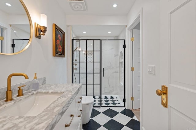 bathroom with a stall shower, vanity, recessed lighting, and toilet
