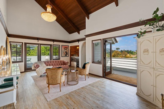 living room with light wood finished floors, high vaulted ceiling, wood ceiling, plenty of natural light, and beamed ceiling