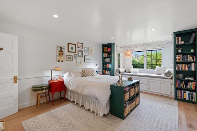 bedroom with light wood finished floors, recessed lighting, and baseboards
